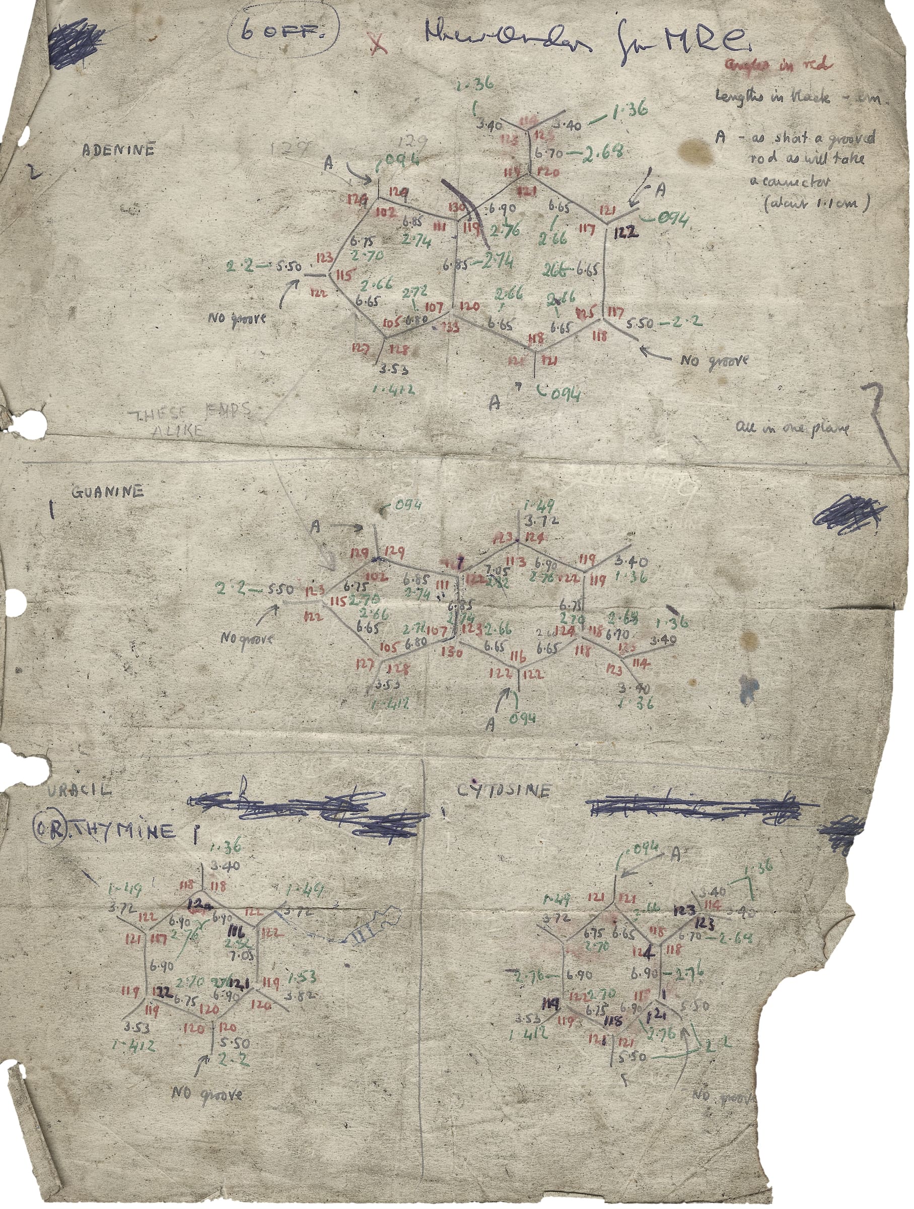 Yellowed paper page with tears in the lower left corner with diagrams and calculations written on it in pencil, and blue, red and green pen.