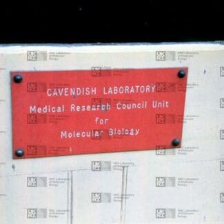 A red rectangular sign for "Cavendish Laboratory Medical Research Council Unit for Molecular Biology" is screwed to a light-colored wall with LMB logo watermark