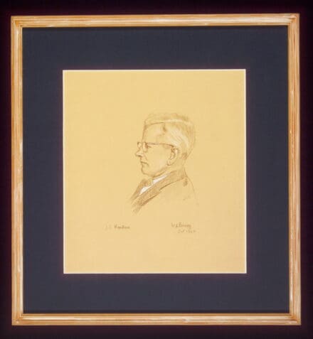 Yellowed paper with black and white sketch of a man in profile, in a wooden frame with a black mount