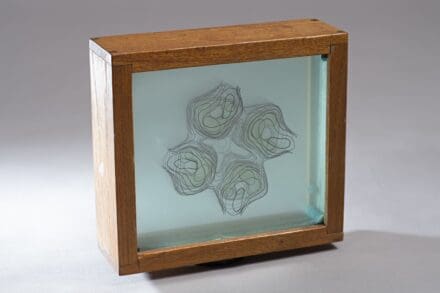 Wooden box frame with layers of glass with different pattern formations on each layer