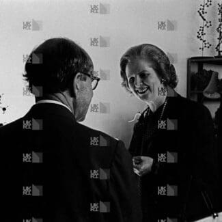 Margaret Thatcher with Max Perutz and a colleague in a laboratory with LMB logo watermark overlay.