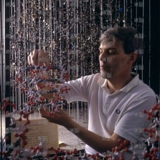 Richard Henderson holding molecular model with LMB logo watermark overlay.