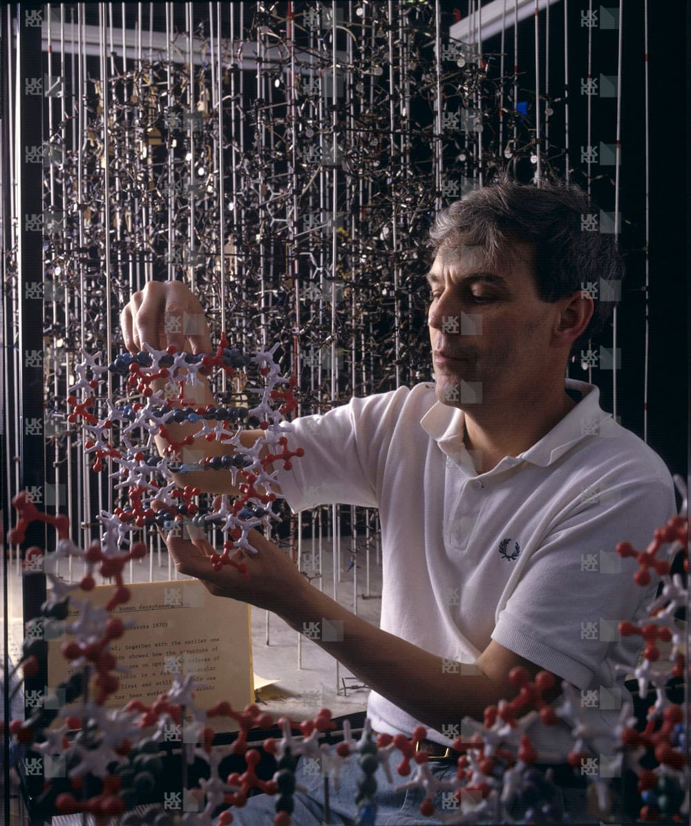 Richard Henderson holding molecular model with LMB logo watermark overlay.
