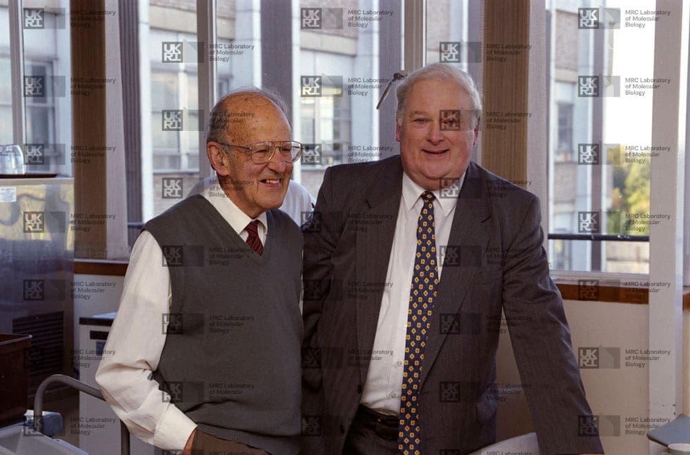 Max Perutz and Michael Fuller with LMB logo watermark overlay.