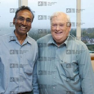 Venki Ramakrishnan and Michael Fuller with LMB logo watermark overlay.