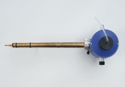 Copper metal rod with a circular blue chamber on the right end