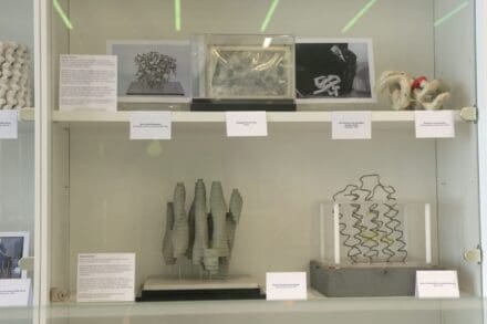 Two shelves of models and photographs