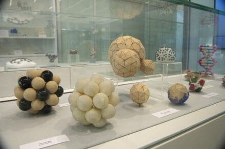Display case with several spherical and geometric-shaped scientific models
