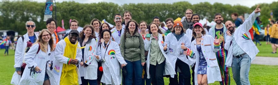 LMB research team at Pride event wearing brightly decorated labcoats