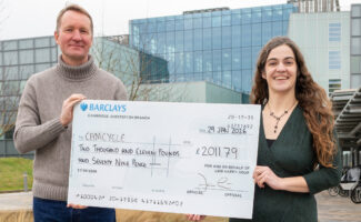 Jan Lowe and Anna Williams holding large check in front of LMB.