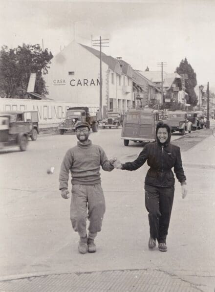 Black and white photo of a couple holding hands in a street