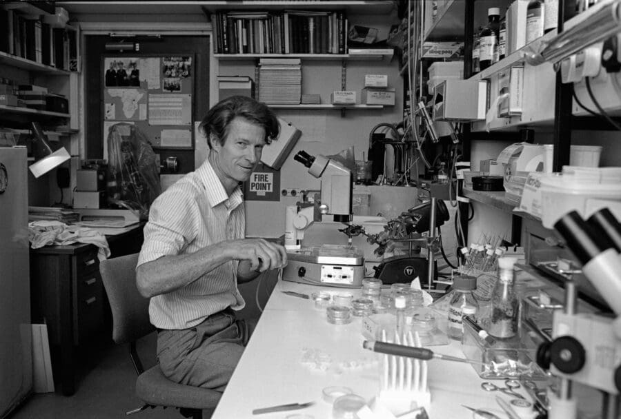 Black and white photo of John Gurdon in the lab