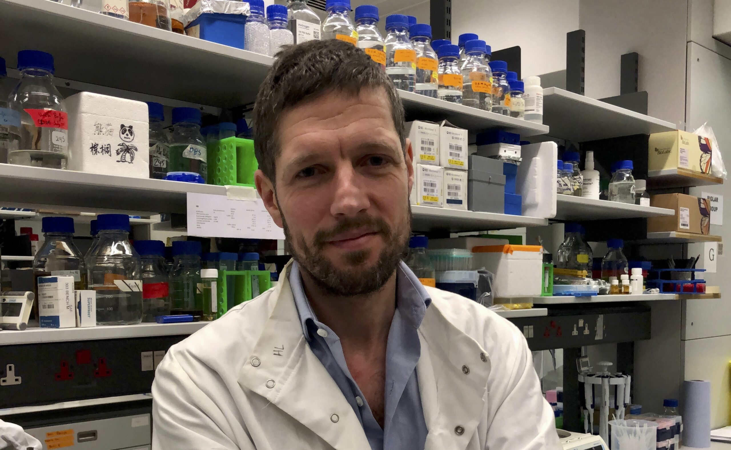 Harry Low wearing a white lab coat