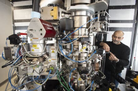 Cryo-EM specialist troubleshooting a high-end cryo electron microscope for high-resolution imaging work.