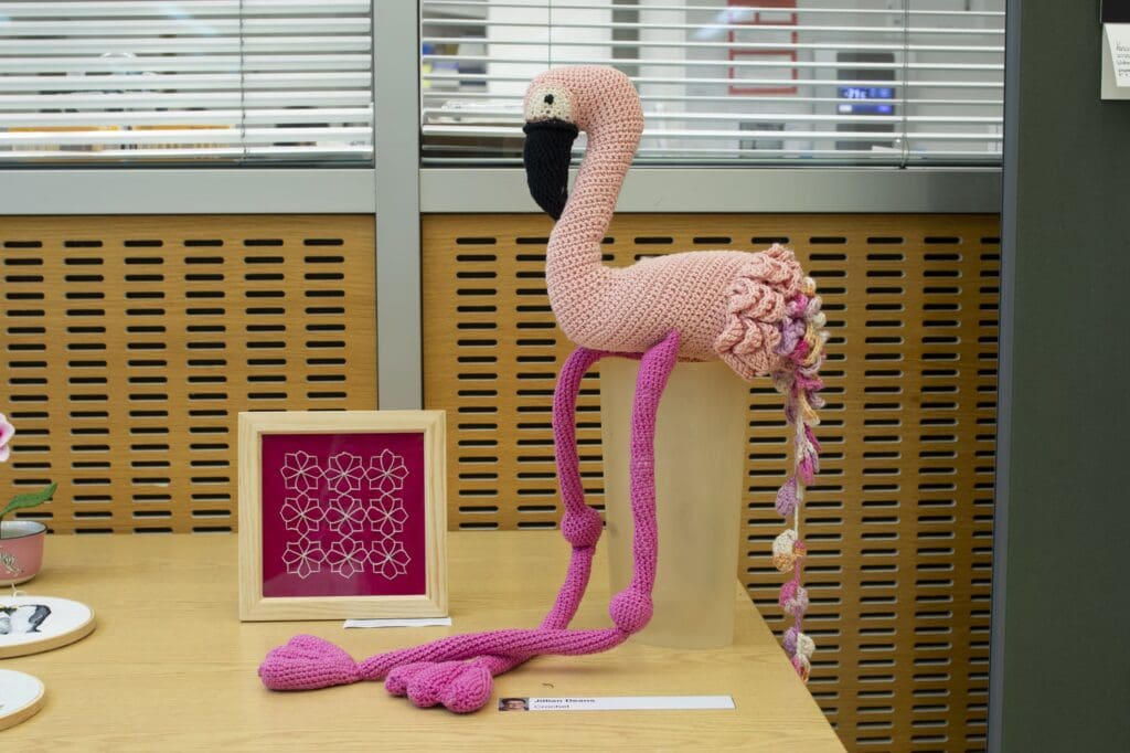 Crocheted flamingo and framed embriodery.