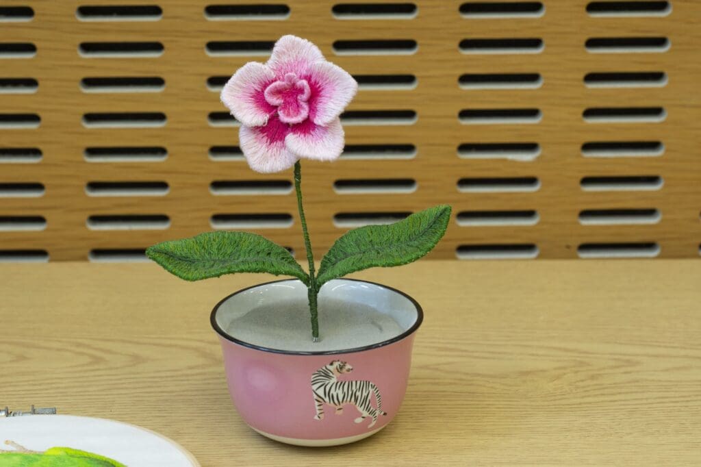 Three-dimensional embroidered flower