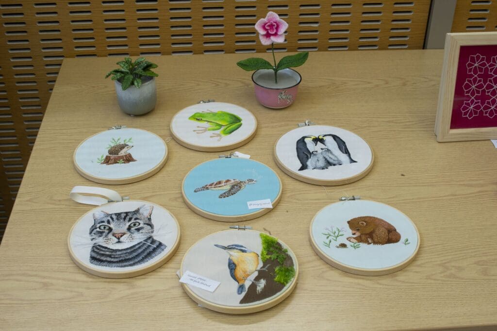 Embroidered circular frames and plants.