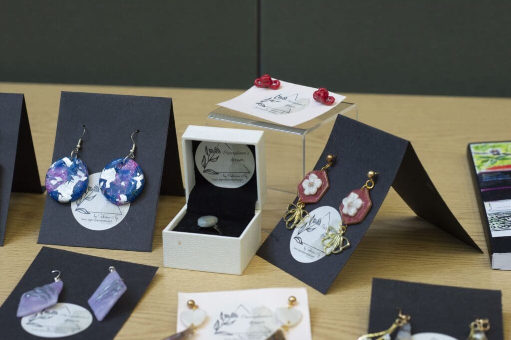 Earrings and rings in display boxes and stands.