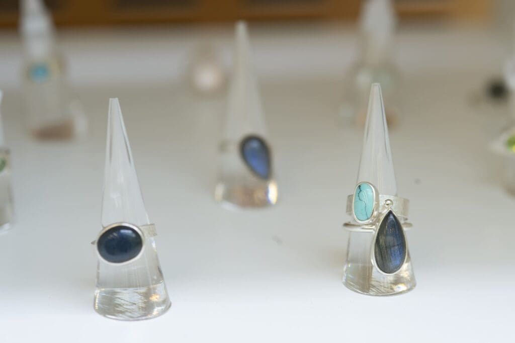 Gemstone rings on individual stands.