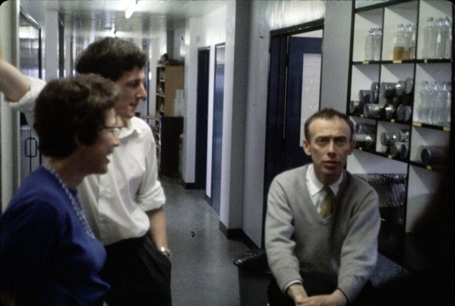 Three people in a corridor