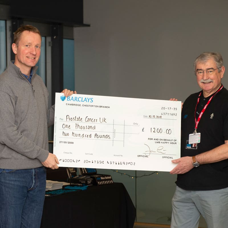 Jan Löwe presents John Mochan from Prostate Cancer UK with the LMB’s donation