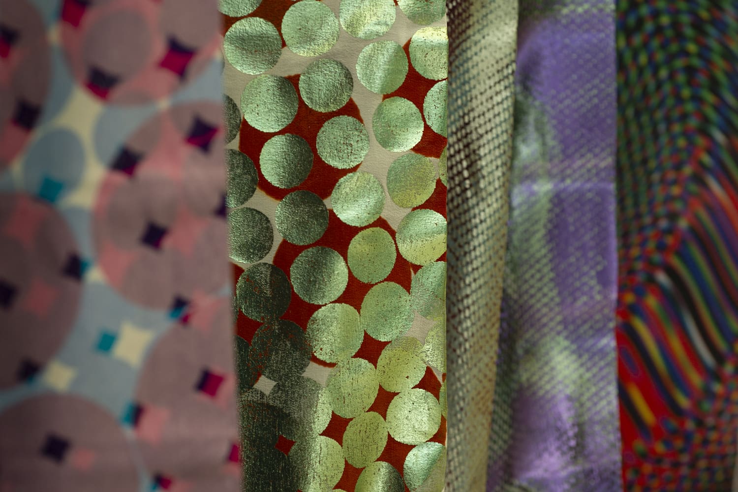 Close up of textiles patterns in various designs and colours.