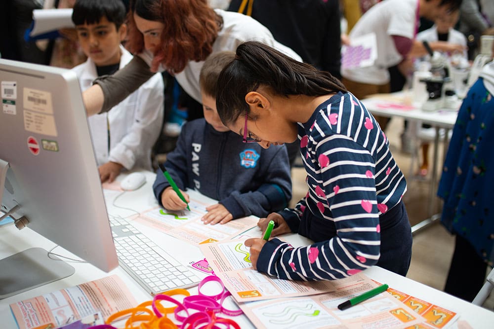 Children learning about worm research in Queensgate Shopping Centre