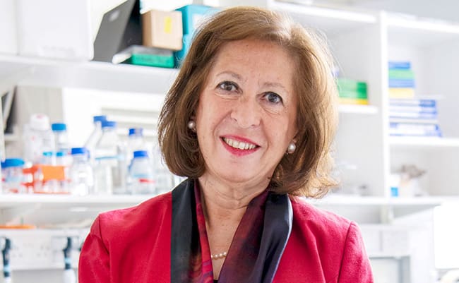 Woman in red blazer looking directly at the camera.