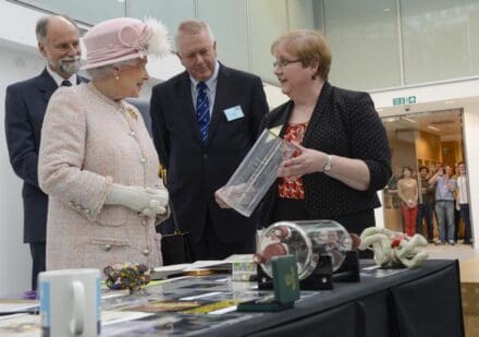 Annette with an Archive display at the Official Opening 2013 with then Director Hugh Pelham, HRH Queen Elizabeth II and then MRC Chief Executive John Savill