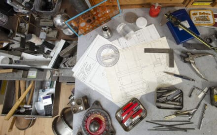 Hand-drawn plotted designs on a workbench